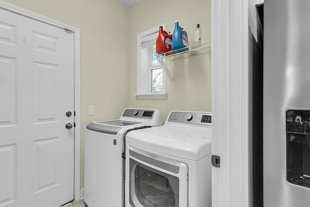 washroom featuring separate washer and dryer and laundry area