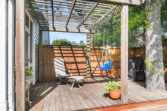 wooden deck featuring fence, a pergola, and a grill