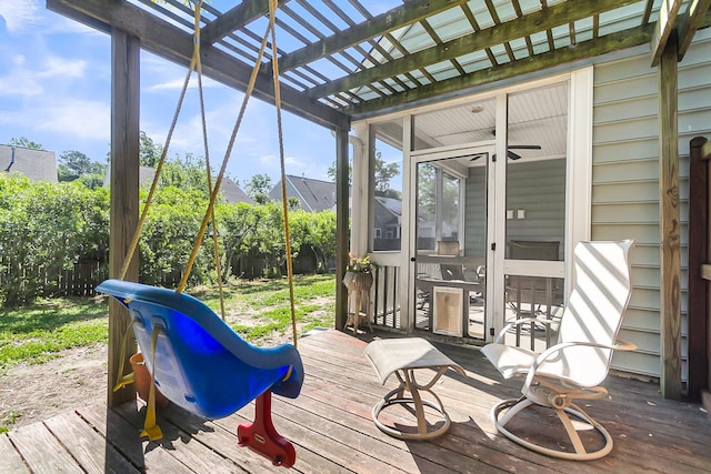 deck featuring a pergola, fence, and a sunroom