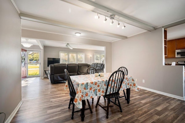 dining area with a healthy amount of sunlight, dark hardwood / wood-style floors, and beam ceiling