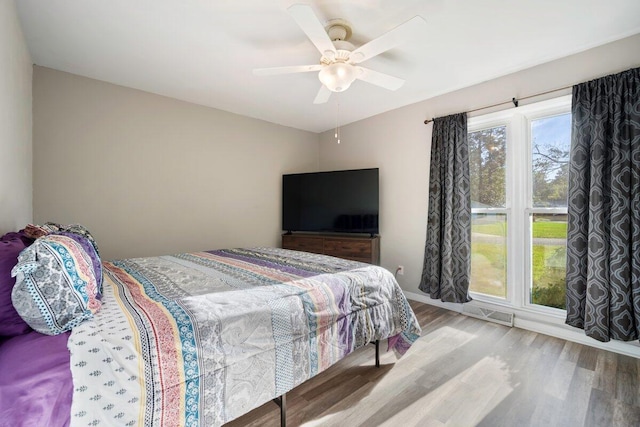 bedroom with wood-type flooring and ceiling fan