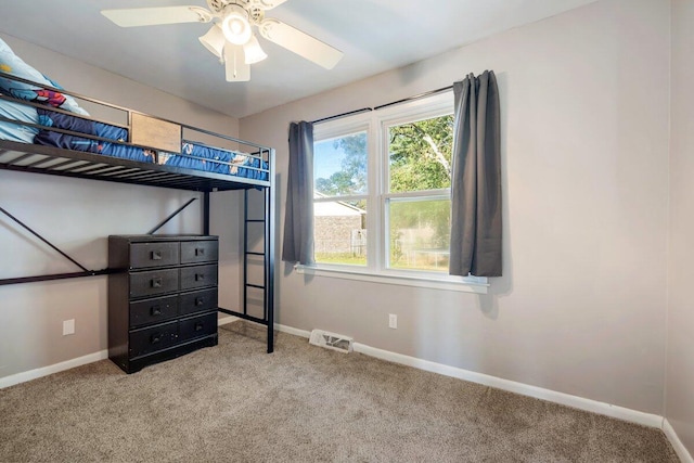 unfurnished bedroom featuring ceiling fan and light carpet