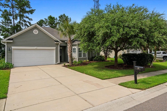 view of front of home featuring a front yard and a garage