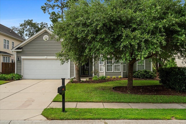 view of property hidden behind natural elements with a front yard and a garage