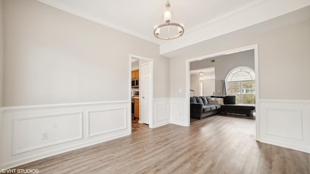 unfurnished room featuring wood-type flooring and crown molding