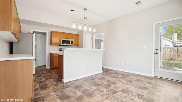 kitchen with hanging light fixtures and tile patterned flooring