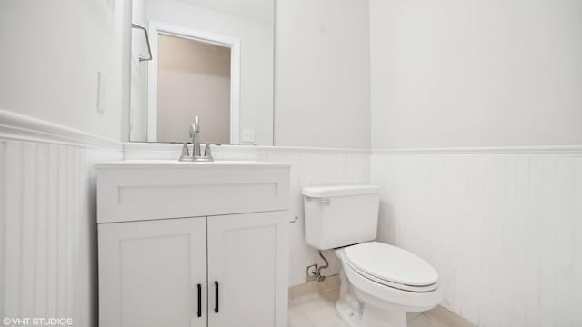 bathroom featuring vanity, toilet, and tile patterned flooring