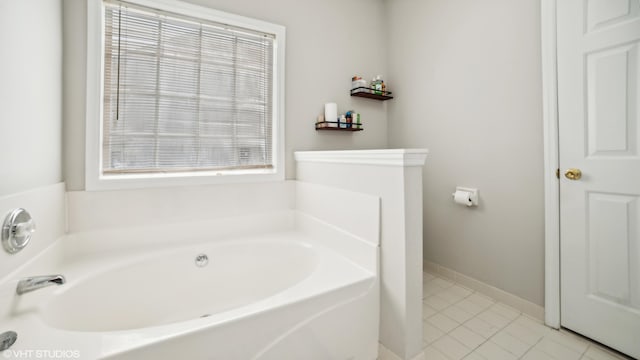 bathroom with tile patterned flooring and a washtub