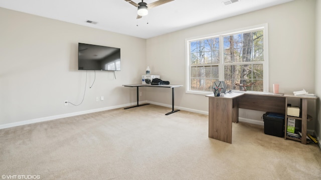 carpeted office space with ceiling fan