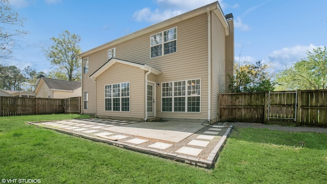 rear view of property featuring a patio and a yard