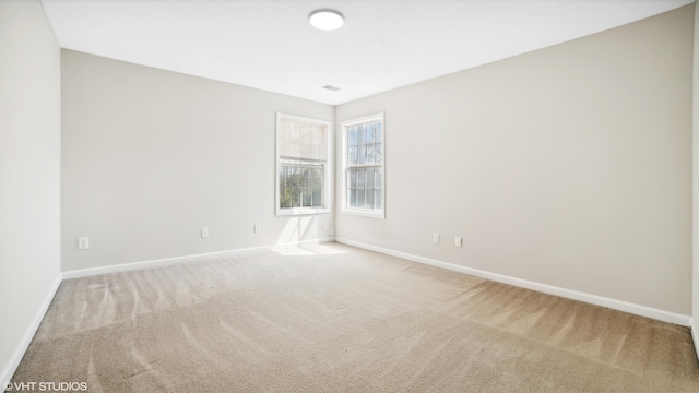 unfurnished room with light carpet