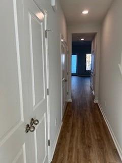 hallway with dark hardwood / wood-style flooring