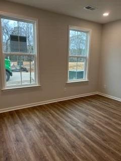 spare room with dark wood-type flooring