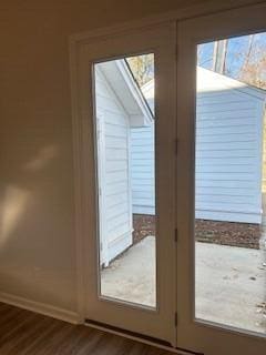 doorway featuring dark wood-type flooring and french doors