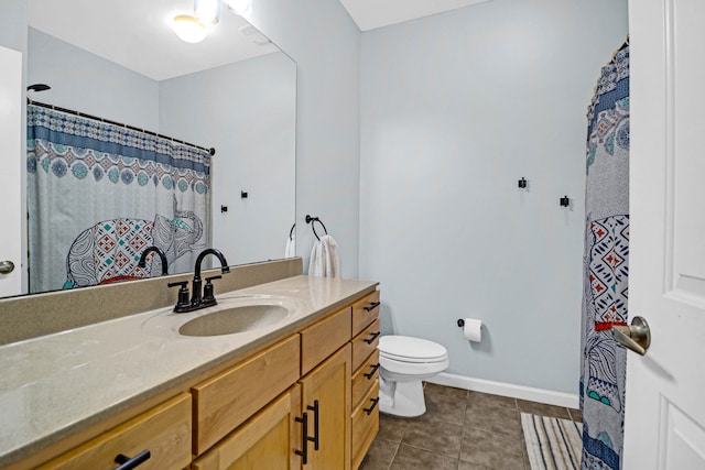 bathroom featuring vanity, tile patterned flooring, and toilet