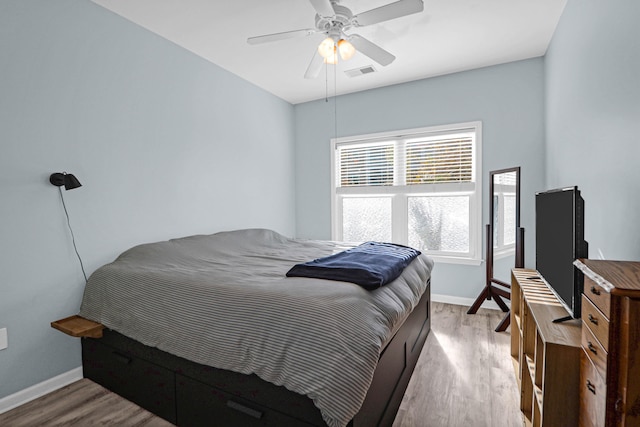 bedroom featuring light wood-type flooring and ceiling fan