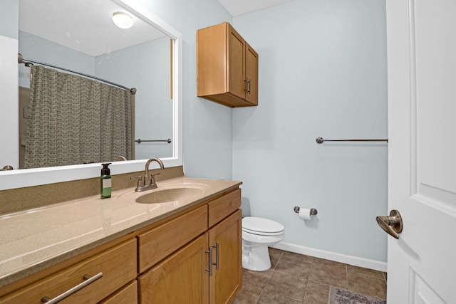 bathroom with toilet, vanity, and a shower with shower curtain