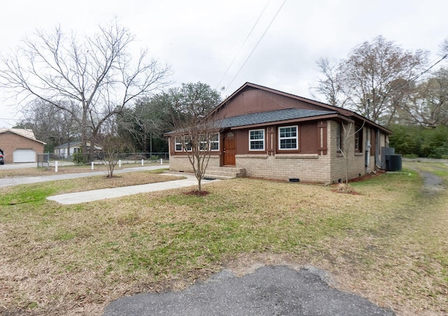 view of side of home with a yard and central AC