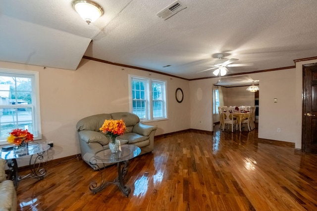 unfurnished room featuring wood-type flooring, a textured ceiling, and a wealth of natural light