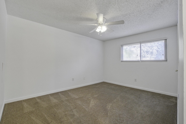 carpeted spare room featuring ceiling fan, baseboards, and a textured ceiling