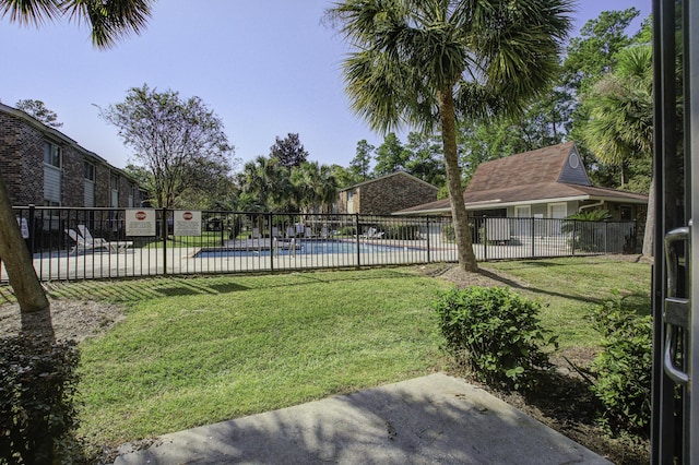 view of yard with a community pool and fence