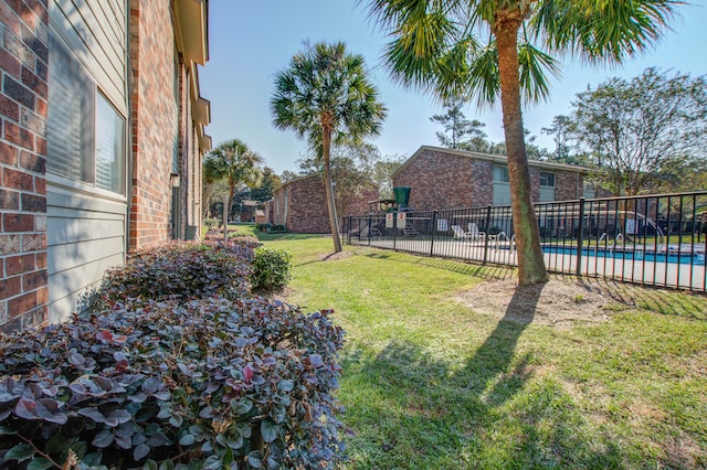 view of yard with a fenced in pool