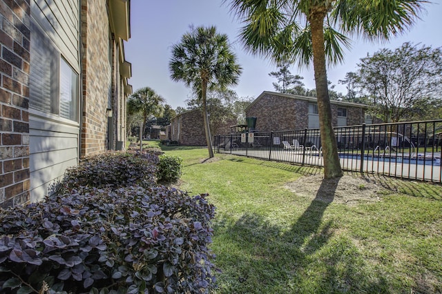 view of yard featuring fence and a fenced in pool