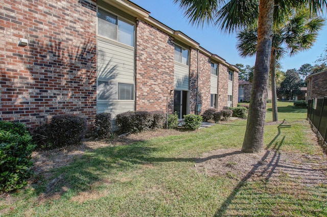 view of side of home featuring a lawn