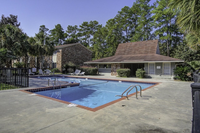 pool featuring a patio and fence