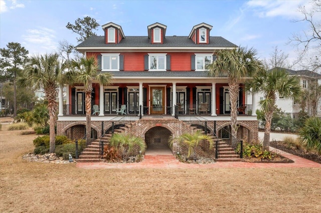 view of front facade with a porch and a front lawn