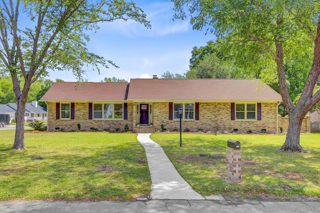 single story home with crawl space, a front lawn, brick siding, and a shingled roof