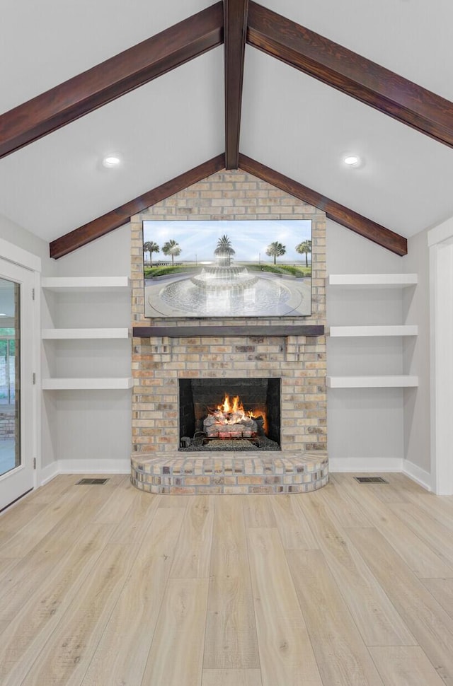 unfurnished living room featuring a fireplace, wood finished floors, built in shelves, and baseboards