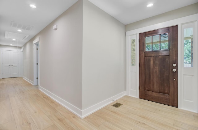 foyer entrance with light wood-type flooring, baseboards, and recessed lighting