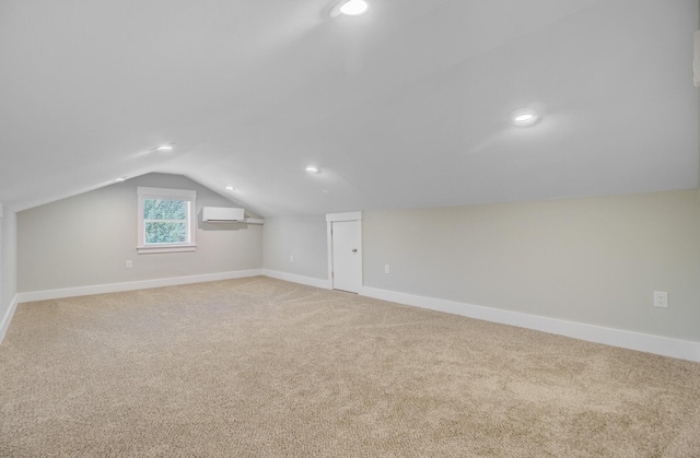 bonus room with a wall unit AC, baseboards, lofted ceiling, light colored carpet, and recessed lighting