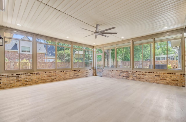 unfurnished sunroom with brick wall, wood finished floors, and wooden ceiling