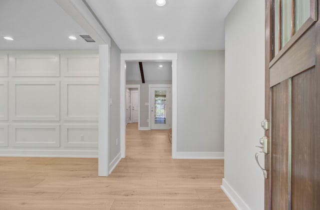entryway featuring baseboards, light wood-style flooring, and recessed lighting