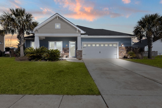 view of front of property featuring a garage and a lawn