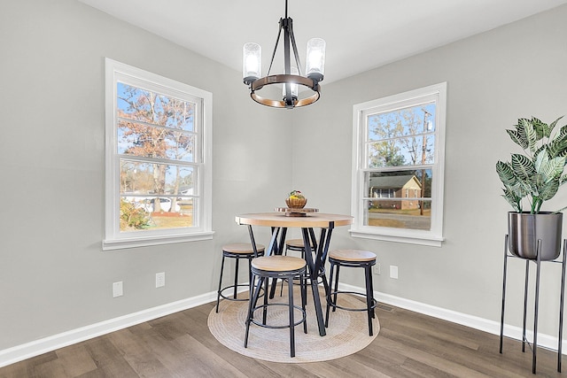 dining room featuring a chandelier, dark hardwood / wood-style flooring, and a healthy amount of sunlight