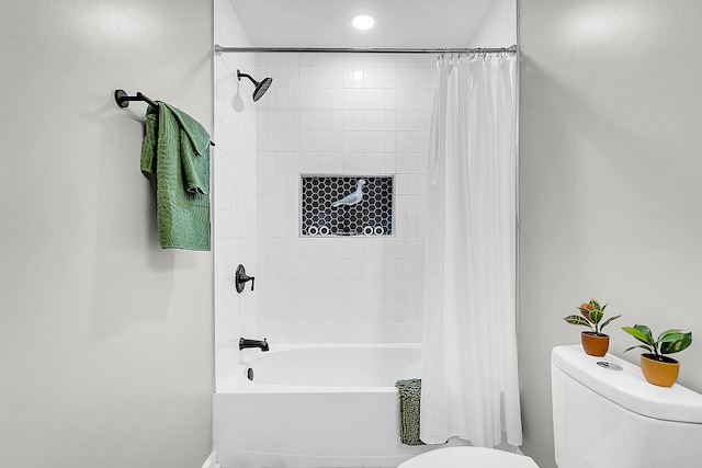 bathroom with shower / bath combination with curtain and toilet