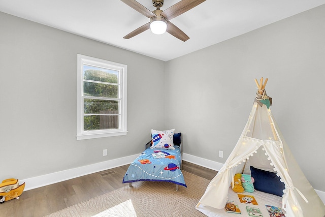 bedroom with ceiling fan and hardwood / wood-style floors