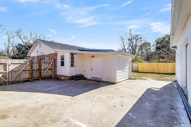 back of house with solar panels