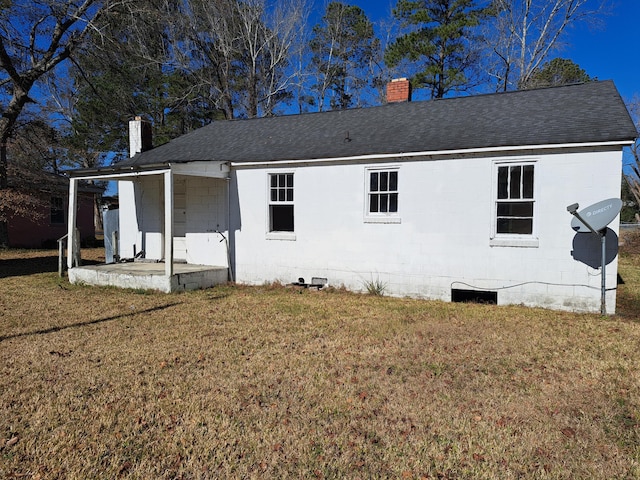 back of house featuring a lawn and a porch