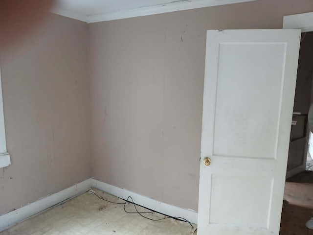 empty room featuring ornamental molding