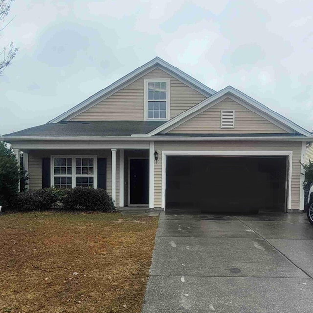 view of front facade with a garage and a front yard