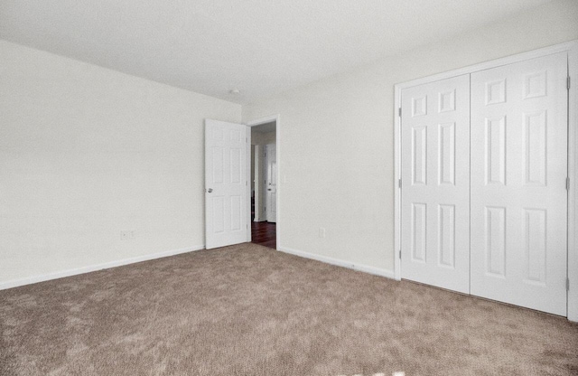 unfurnished bedroom with carpet floors and a closet