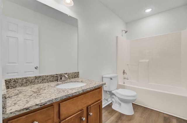 full bathroom with vanity, wood-type flooring, shower / washtub combination, and toilet