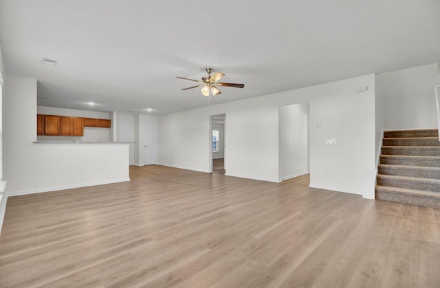 unfurnished living room featuring light hardwood / wood-style floors and ceiling fan