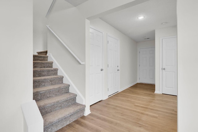 stairway with wood-type flooring