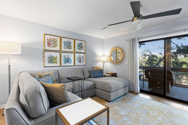 living room featuring ceiling fan and light hardwood / wood-style flooring