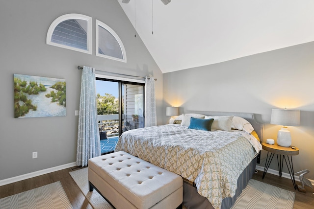 bedroom featuring hardwood / wood-style flooring, high vaulted ceiling, and access to exterior